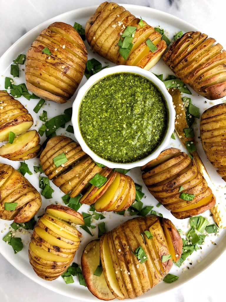 Sharing these Whole30 Hasselback Potatoes with Garlicky Basil Pesto. Extra crispy potatoes paired with the dreamiest dairy-free pesto. A delicious vegan Whole30 recipe!