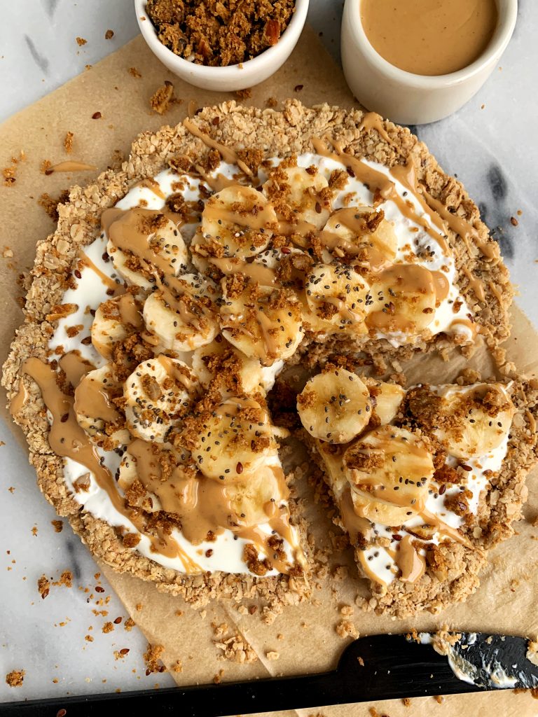 The Ultimate Breakfast Pizza recipe made with all gluten-free and vegan ingredients. A delicious oatmeal crust topping with your favorite yogurt, fruit, nut butter, anything! Perfect to bring to brunch party or make ahead for the week.