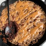 This Paleo Salted Caramel Brownie Skillet is the best most fudgey chocolatey brownie recipe ever. Plus it is lower in sugar and is made with all gluten-free, dairy-free and refined sugar-free ingredients. 