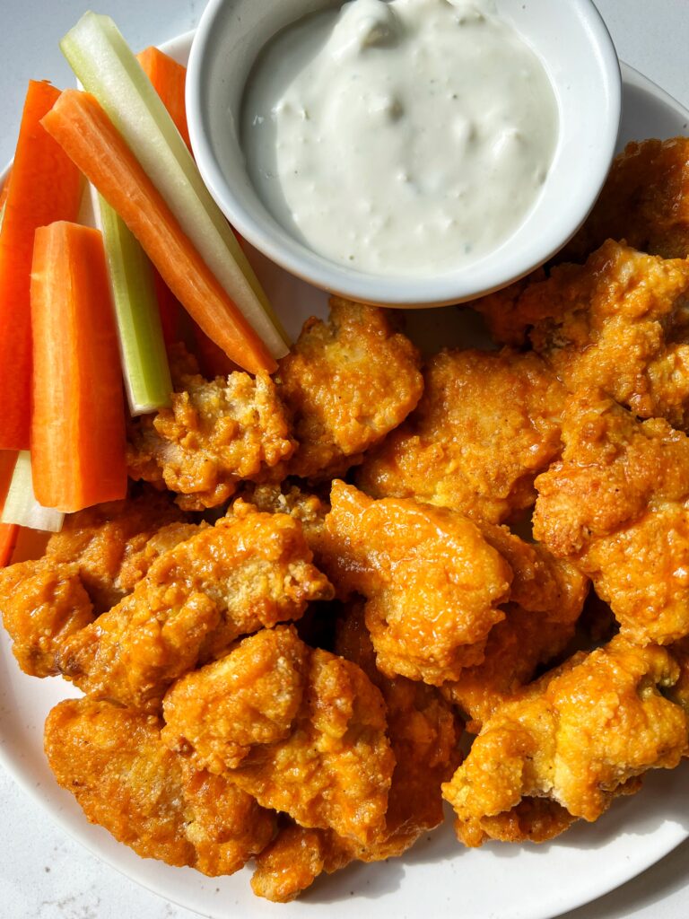 The Best Paleo Buffalo Chicken Nuggets made in the air fryer or in the oven! Takes 20 minutes to cook and we share our secrets on how to get CRISPY and healthy chicken nuggets.