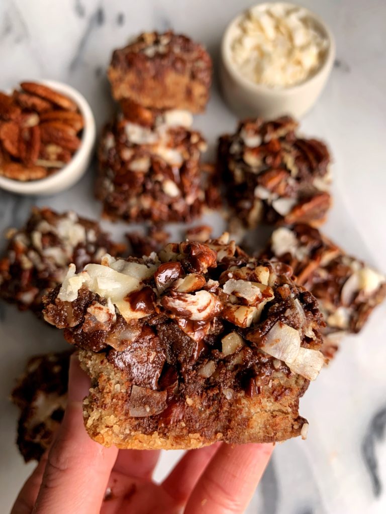 The Most Magical Magic Cookie Bars made with all vegan and paleo ingredients. A healthier twist on magic cookie bars with a doughy cookie base and pecan, chocolate and coconut topping!