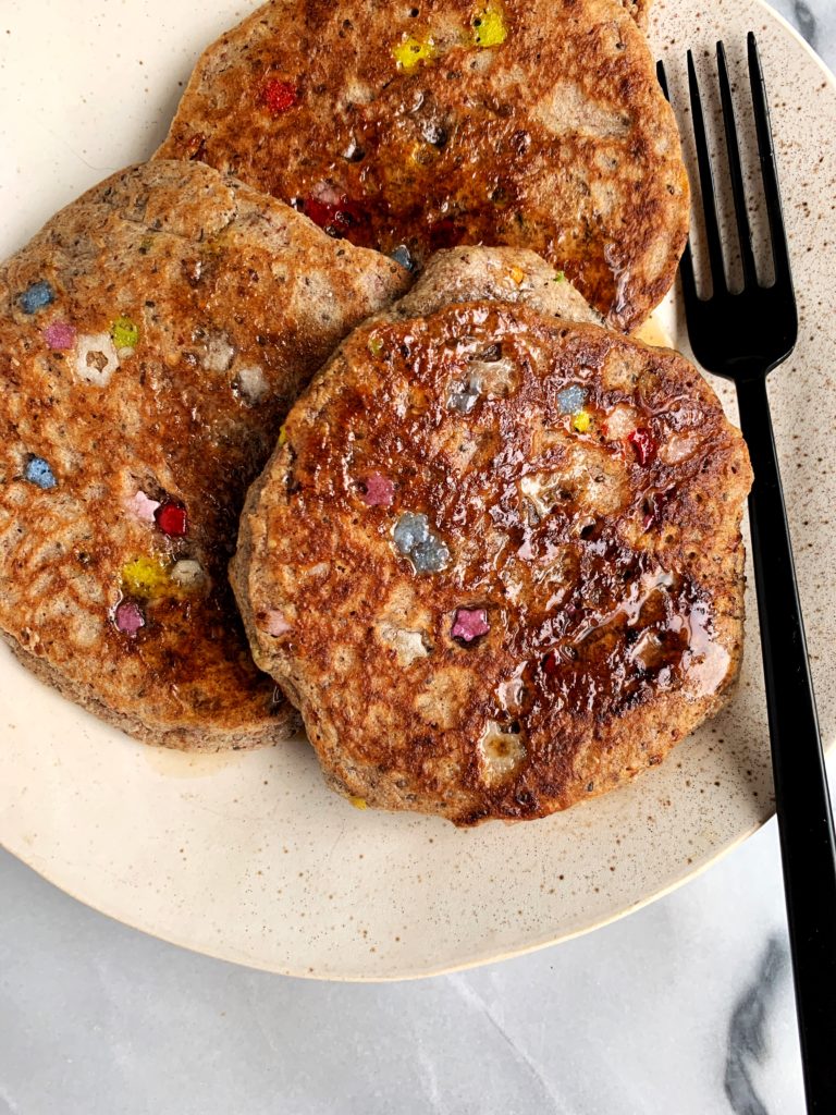 Fluffy Vegan Birthday Cake Pancakes made with all gluten-free ingredients. These are the ultimate lower in sugar healthy pancakes that still taste delicious and are perfect for any occasion!