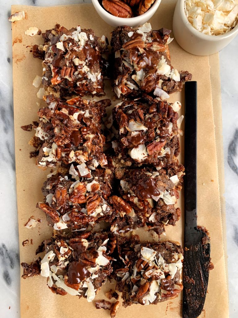 The Most Magical Magic Cookie Bars made with all vegan and paleo ingredients. A healthier twist on magic cookie bars with a doughy cookie base and pecan, chocolate and coconut topping!