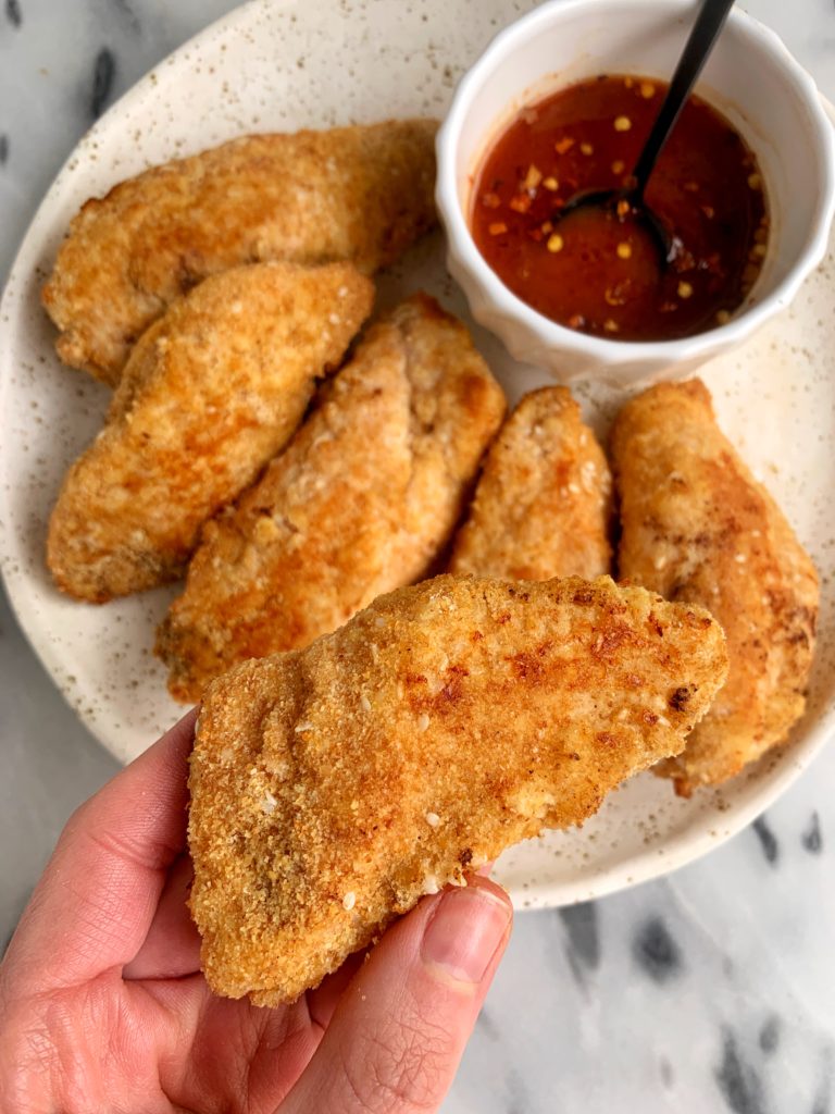 These Paleo Crispy Sesame Chicken Tenders with Spicy Honey Sauce are ready in just 20 minutes and they are gluten-free, nut-free and made with healthy ingredients like ground flaxseed, coconut flour and sesame seeds.