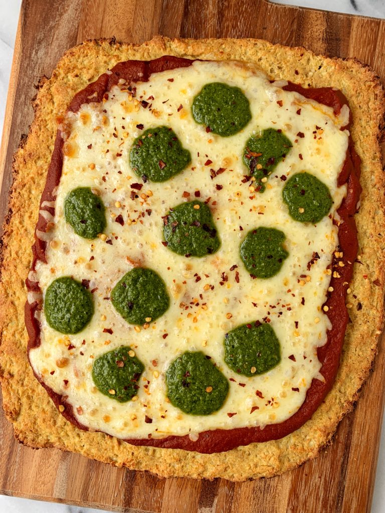 Sharing the BEST Cauliflower Pizza Crust ever! This recipe uses frozen cauliflower rice and it is also paleo, dairy-free and this cauliflower crust is extra crispy and doesn't fall apart.