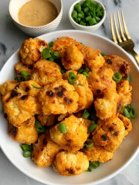 These extra crispy baked buffalo cauliflower wings are the ultimate veggie dish with a little kick! They are vegan, paleo and whole30 and they are so flavorful and simple to make!
