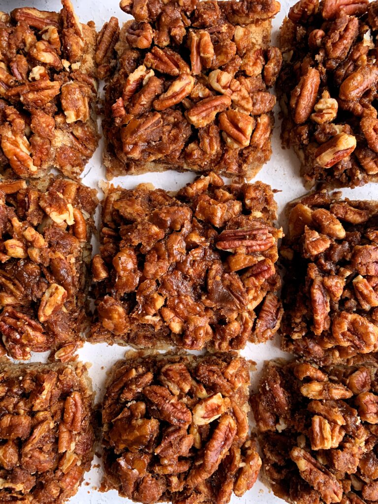 The Best Ever Healthy Pecan Pie Bars made with all paleo and vegan ingredients. A delicious shortbread cookie-like base topped with sweetened pecans and this recipe has no refined sugars, gluten or dairy.