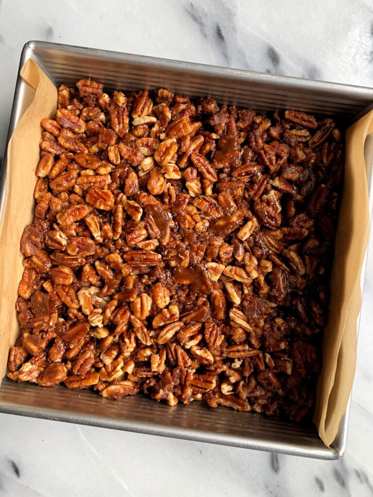 The Best Ever Healthy Pecan Pie Bars made with all paleo and vegan ingredients. A delicious shortbread cookie-like base topped with sweetened pecans and this recipe has no refined sugars, gluten or dairy.