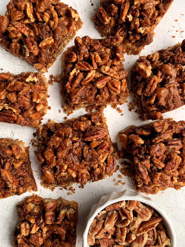 The Best Ever Healthy Pecan Pie Bars made with all paleo and vegan ingredients. A delicious shortbread cookie-like base topped with sweetened pecans and this recipe has no refined sugars, gluten or dairy.