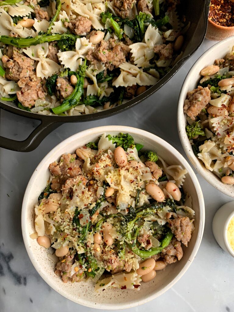 This delicious Gluten-free Broccoli Rabe + Sausage Pasta is one of our family favorite dinner recipes. It is easy to prepare and a healthier version of the classic pasta dish and it is so flavorful. 