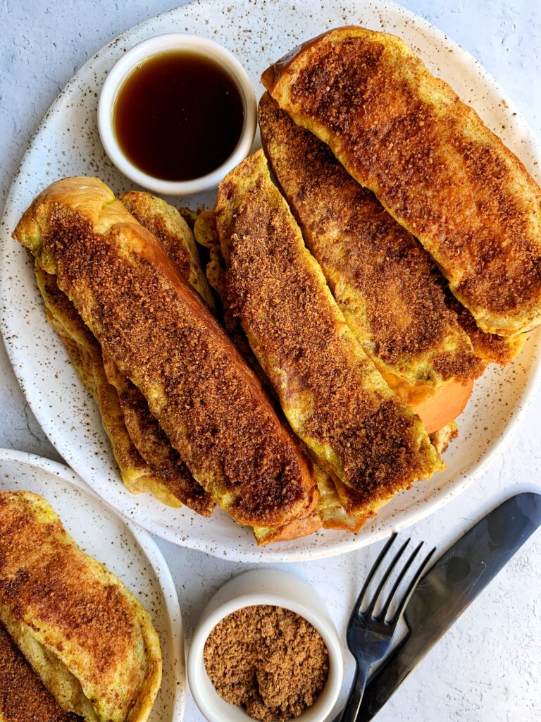 The BEST Cinnamon Sugar Challah French Toast Sticks! These are the ultimate breakfast or brunch recipe to make when you are craving french toast and they are made in the oven.