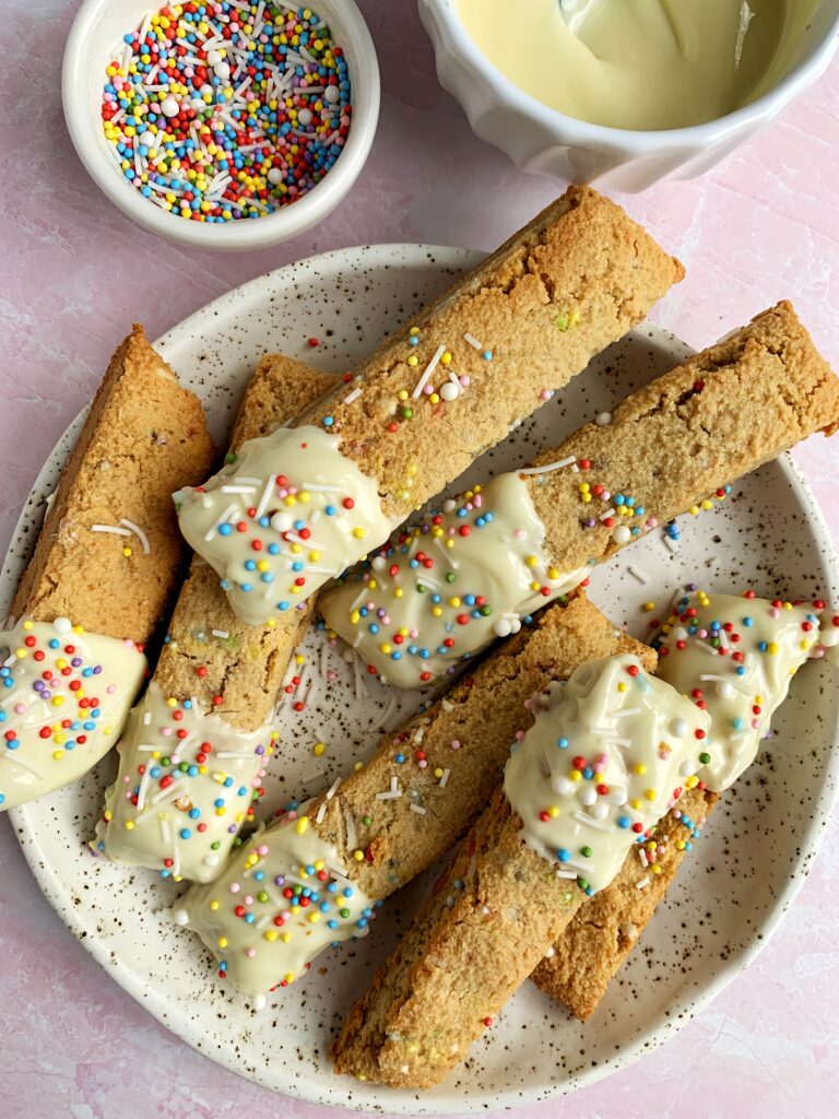 Delicious Gluten-free Funfetti Biscotti made with all vegan and grain-free ingredients. Perfectly crunchy biscotti filled with sprinkles and dipped in white chocolate for an absolutely delectable cookie recipe!