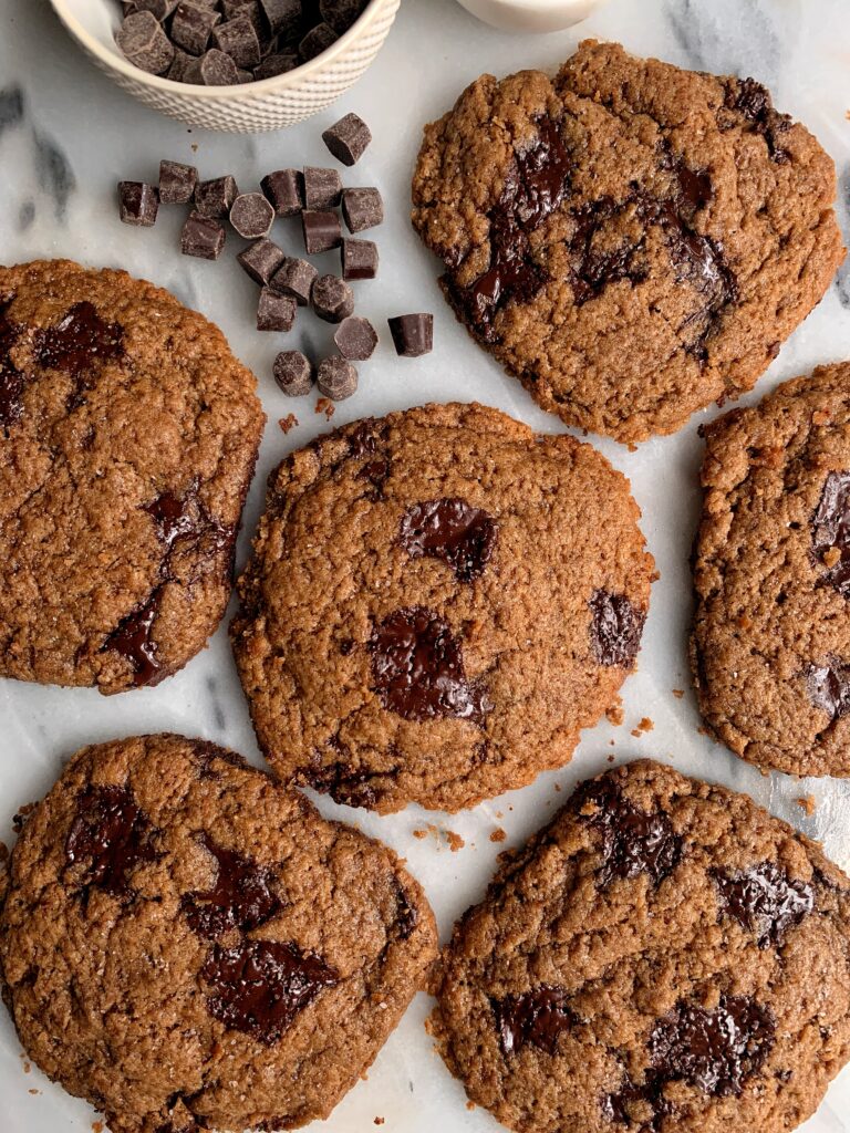 Healthier Bakery-Style Chocolate Chip Cookies made with all gluten-free and vegan ingredients. These taste just like the sea salt chocolate chip cookies from the local bakery and have the best soft gooey center.