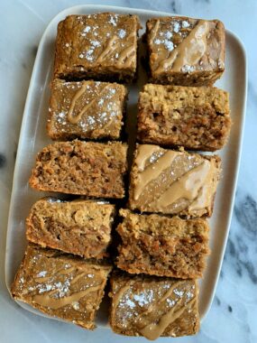 These Gluten-free Carrot Cake Cheesecake Bars are absolutely delicious. A carrot cake base made with all gluten and grain-free ingredients topped off with a cheesecake topping made with 3 ingredients! 