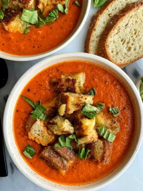 This healthier Vegan Creamy Tomato Soup with Grilled Cheese Croutons is the ultimate comfort food recipe! The dairy-free soup is made with 5 ingredients and topped with delicious grilled cheese made into "croutons".