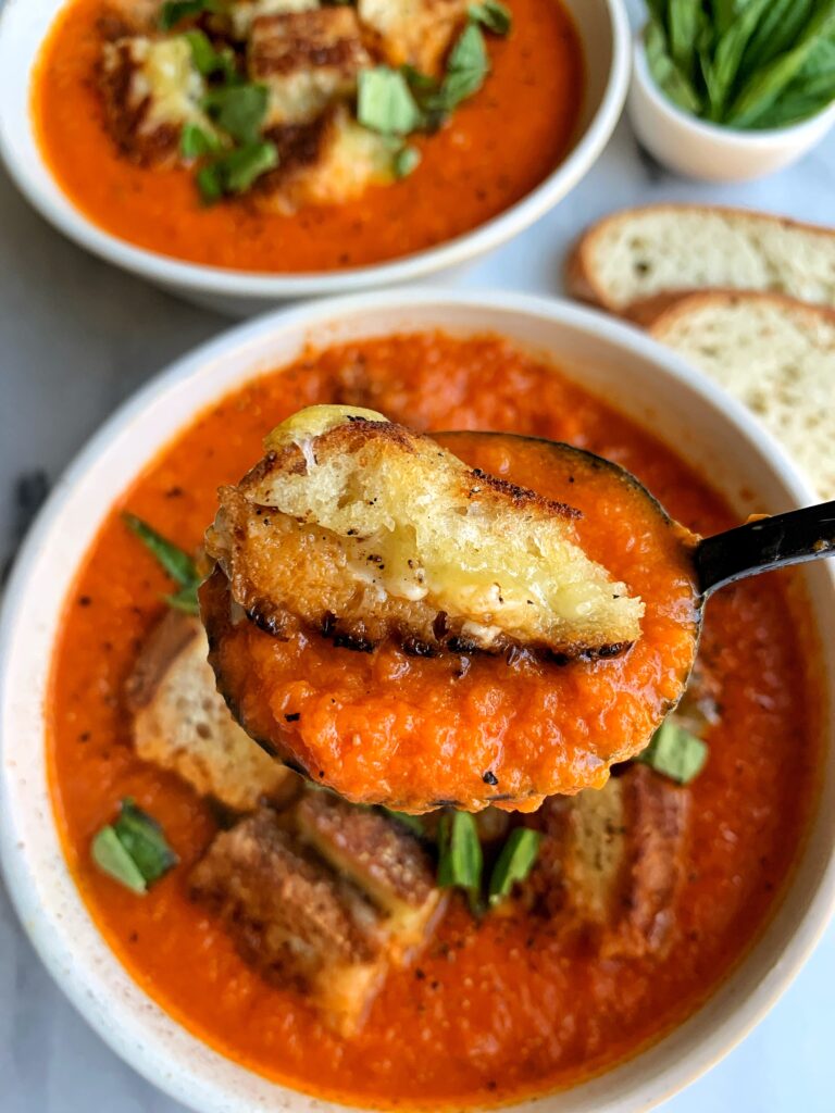 This healthier Vegan Creamy Tomato Soup with Grilled Cheese Croutons is the ultimate comfort food recipe! The dairy-free soup is made with 5 ingredients and topped with delicious grilled cheese made into "croutons".