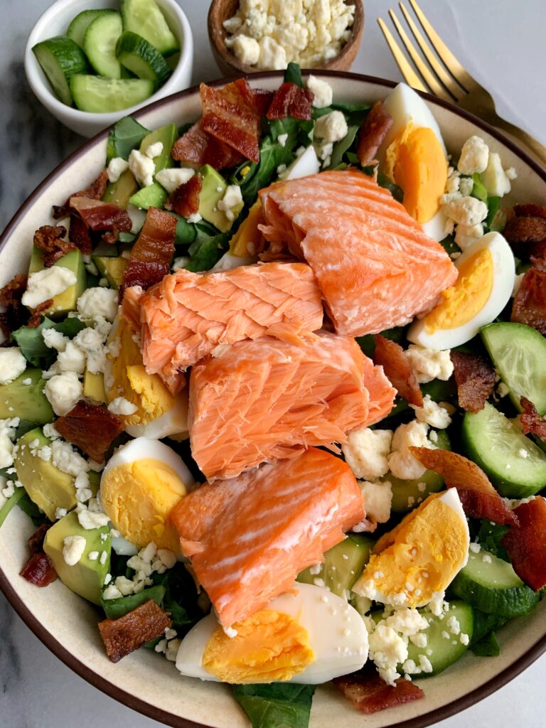 A Delicious Salmon Cobb Salad for a twist on the classic cobb salad recipe. One of our favorite go-to salads to make and pair with any dressing you're are craving!