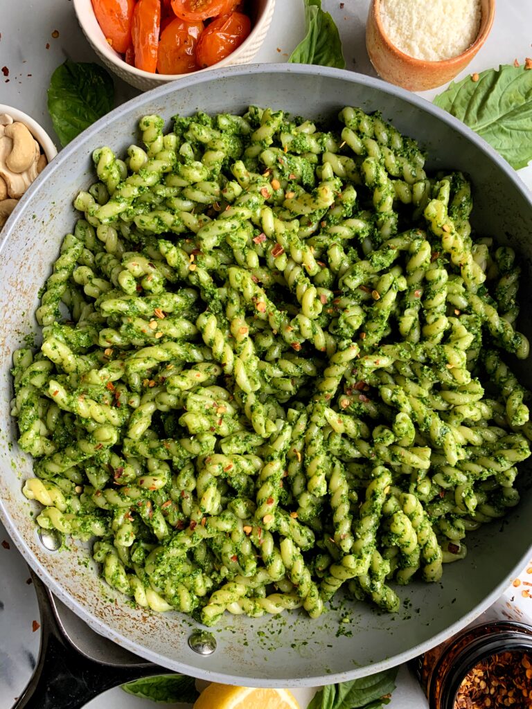 Vegan Cashew Kale Pesto Pasta made with all gluten-free and dairy-free ingredients. This easy pesto pairs perfectly with your favorite pasta and with some delicious roasted tomatoes mixed in for a dreamy vegan dish!