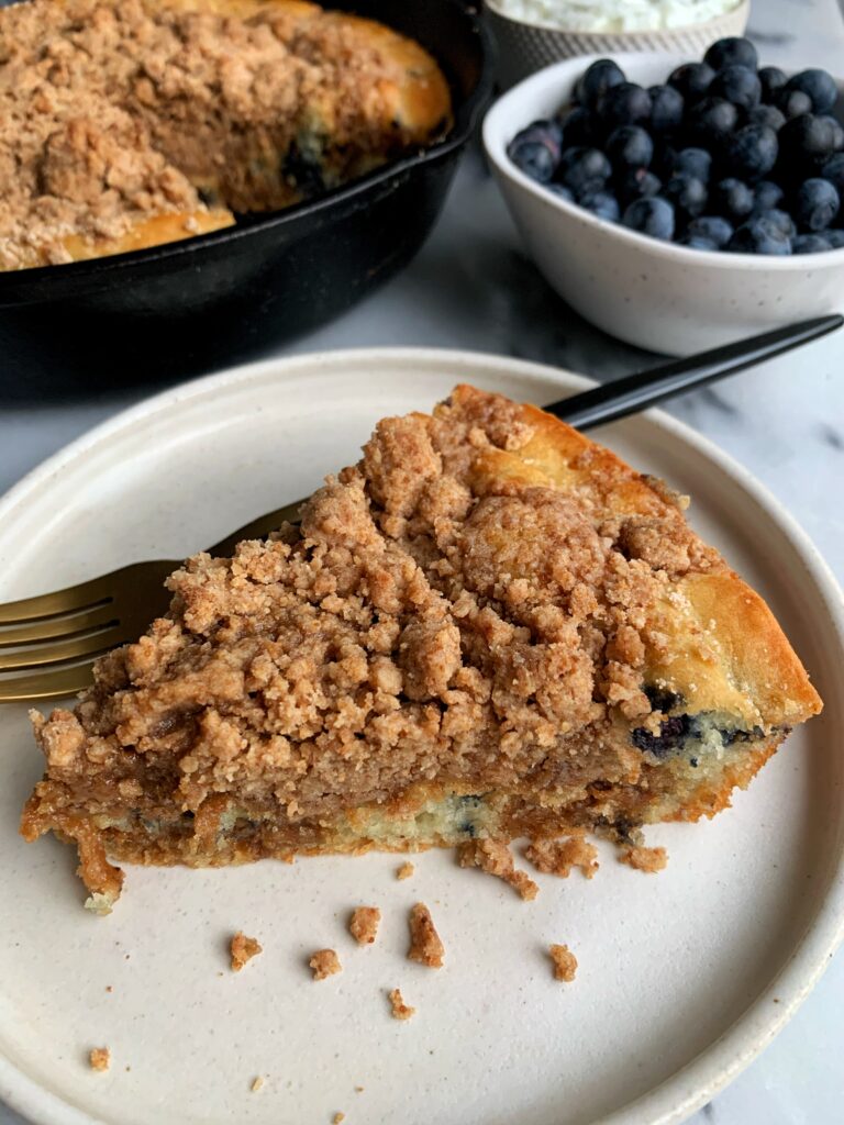INSANE Blueberry Crumb Cake Pancake Skillet! Blueberry pancake cake made with a family classic pancake mix + topped with a delicious crumb topping ready in 25 minutes.