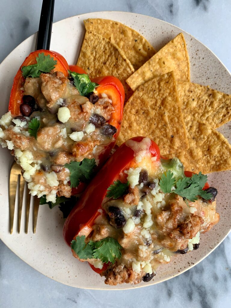 Sharing these easy and healthy Taco Stuffed Peppers! A delicious dinner recipe that is made with all gluten-free and grain-free ingredients. Plus it only takes 20 minutes to whip up for an easy weeknight meal.