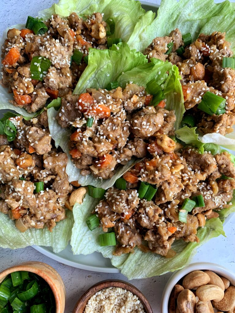 Healthy and flipping delicious Cashew Chicken Lettuce Cups! A twist on the PF Chang's classic lettuce wraps made with all gluten-free, Whole30 and paleo ingredients.