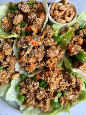 Healthy and flipping delicious Cashew Chicken Lettuce Cups! A twist on the PF Chang's classic lettuce wraps made with all gluten-free, Whole30 and paleo ingredients.