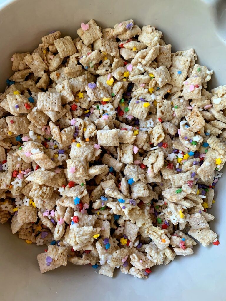 INSANE Funfetti Puppy Chow Recipe! Made with all gluten-free and vegan-friendly ingredients. This is a delicious spin on your favorite puppy chow recipe.