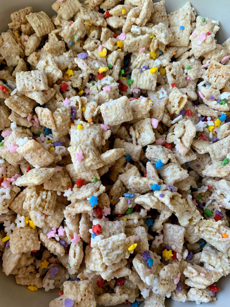 INSANE Funfetti Puppy Chow Recipe! Made with all gluten-free and vegan-friendly ingredients. This is a delicious spin on your favorite puppy chow recipe.