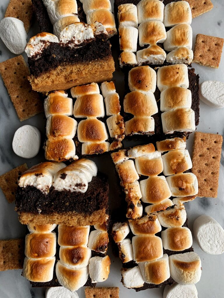 The Absolute Best S'MORES BROWNIE BARS! These s'mores bars are epic filled with a graham cracker base, brownie center and marshmallows on top. And they happen to be gluten-free and you only need a few ingredients to whip them up.