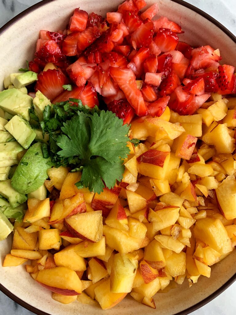 Dreamy Peach Strawberry Avocado Salsa made with only 5 ingredients and takes 10 minutes to make. Breakout your favorite chips and enjoy your new favorite (no onion) summery healthy salsa!