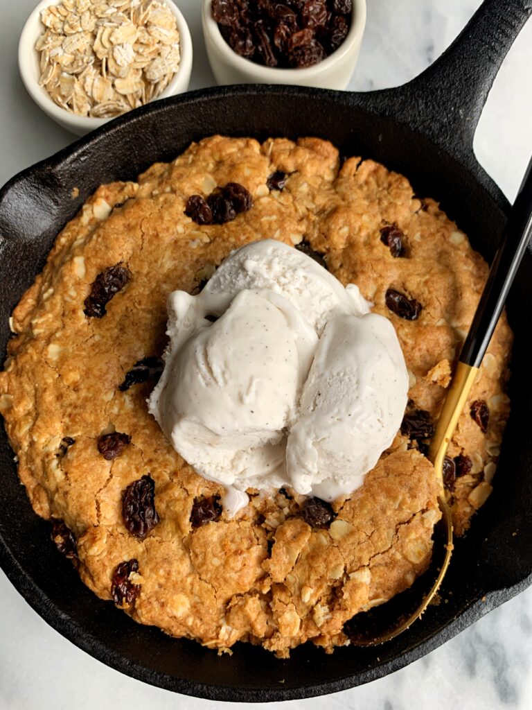 Deep Dish Oatmeal Raisin Cookie Skillet made with all gluten-free, dairy-free and nut-free ingredients! This is the ultimate healthier giant oatmeal cookie that tastes killer with your favorite ice cream on top.