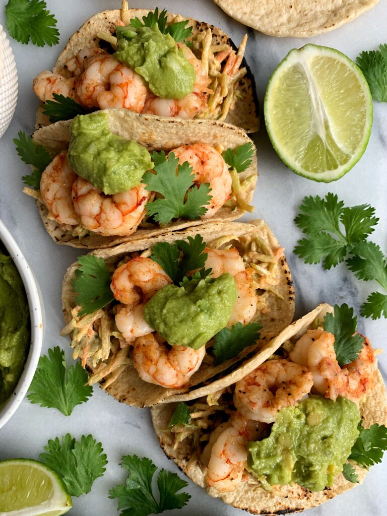 Easy Shrimp Tacos with a delicious spicy slaw! This is one of those super simple healthy recipes that comes together in just 15 minutes!