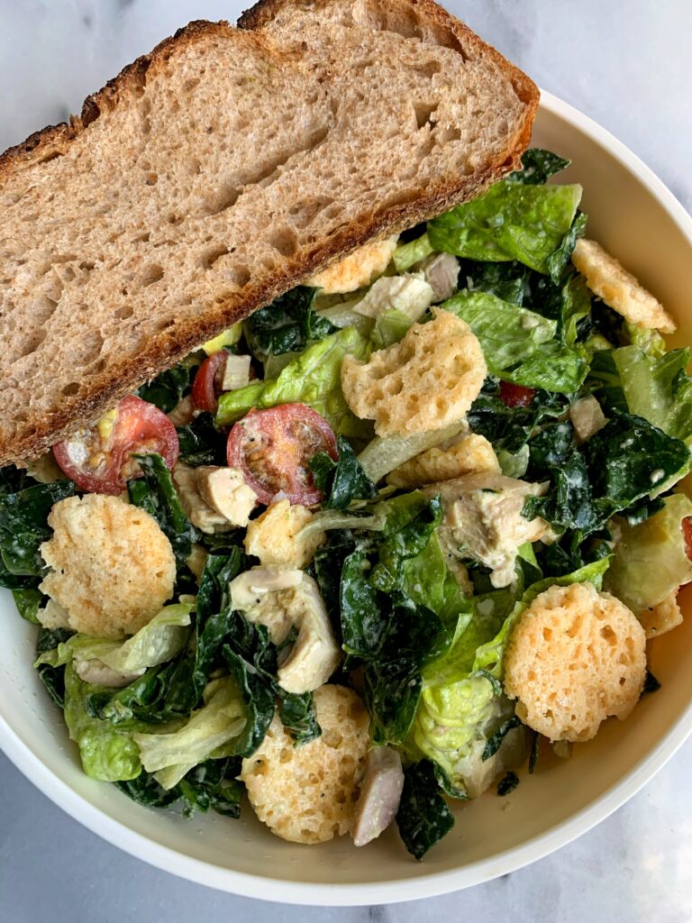 This Copycat Sweetgreen Kale Caesar Salad is basically better than the real deal. Super simple and easy to make and you will think you are at your favorite salad joint eating it!