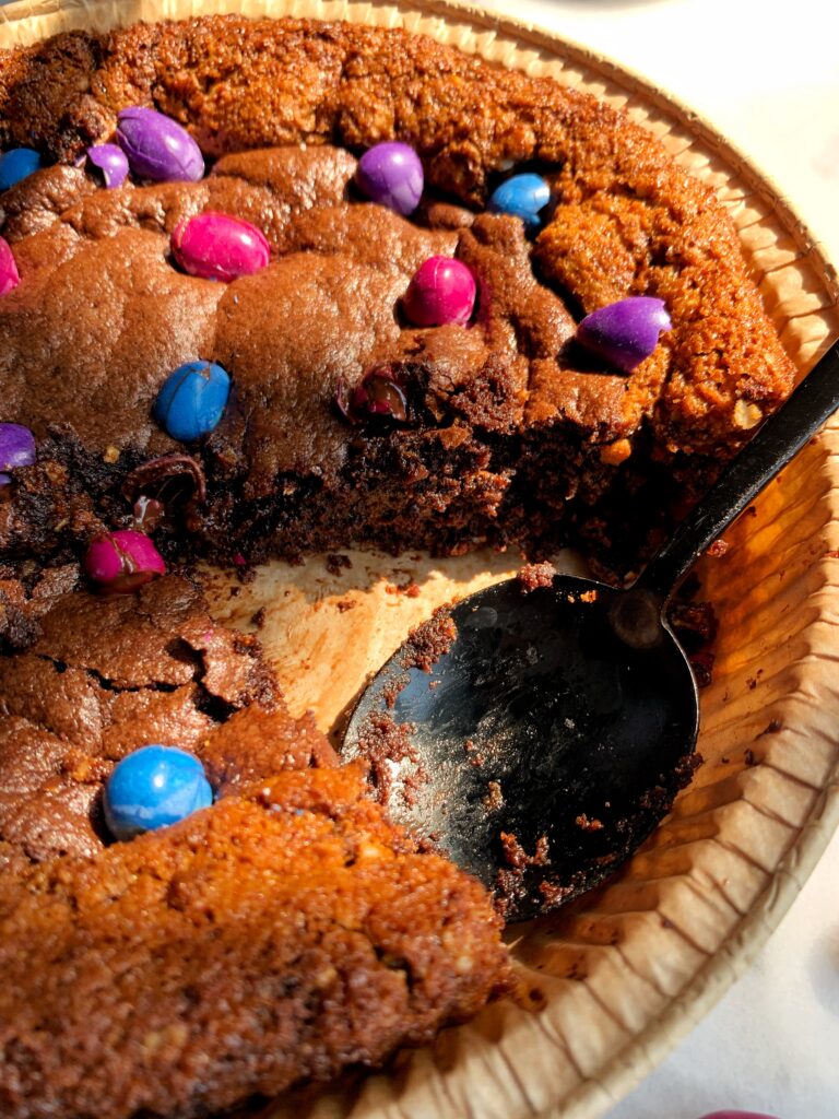INSANE Monster Cookie Brownie Pie! The most delicious best of both worlds dessert with a gluten-free monster cookie base and filled with fudgy brownies.