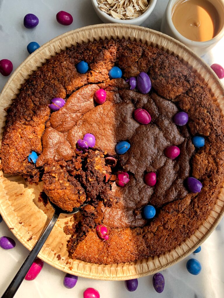 INSANE Monster Cookie Brownie Pie! The most delicious best of both worlds dessert with a gluten-free monster cookie base and filled with fudgy brownies.