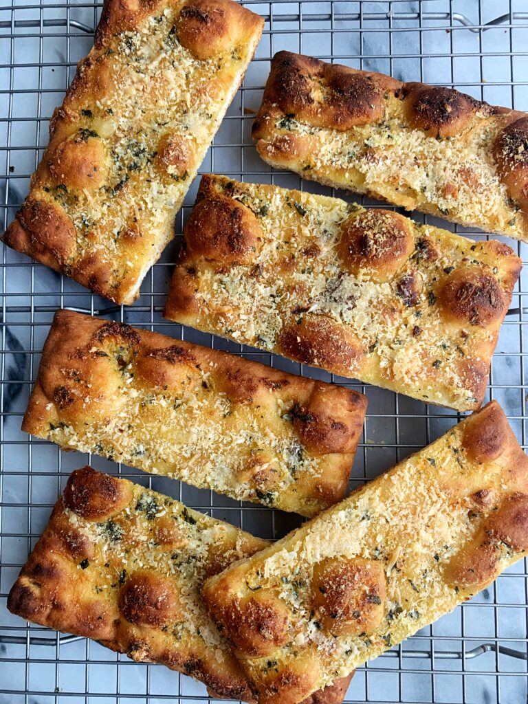 Crispy Herby DELISH Garlic Bread! This is seriously some of the best garlic bread ever. Plus we made it extra crunchy and cheesy and with fresh herbs.