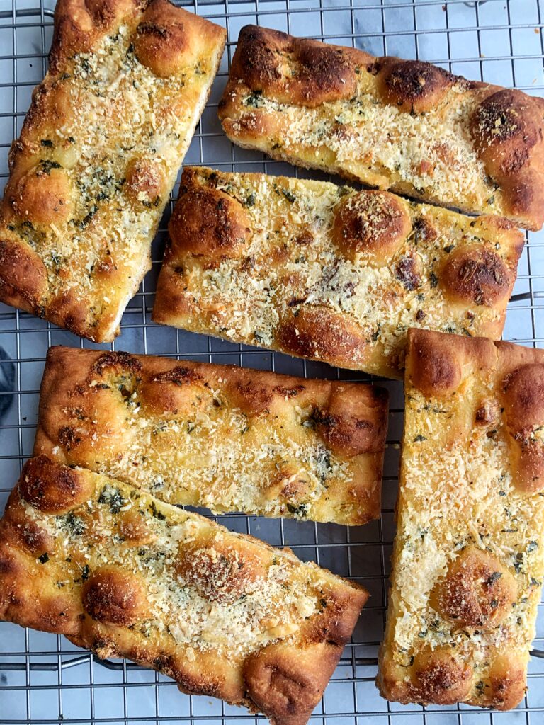 Crispy Herby DELISH Garlic Bread! This is seriously some of the best garlic bread ever. Plus we made it extra crunchy and cheesy and with fresh herbs.