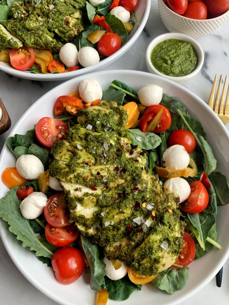 This Pesto Chicken Caprese Salad is the ultimate salad to make everybody. It spices things up in your salad bowl, with your chicken game and the flavors with the tomatoes and mozzarella are out of this world!