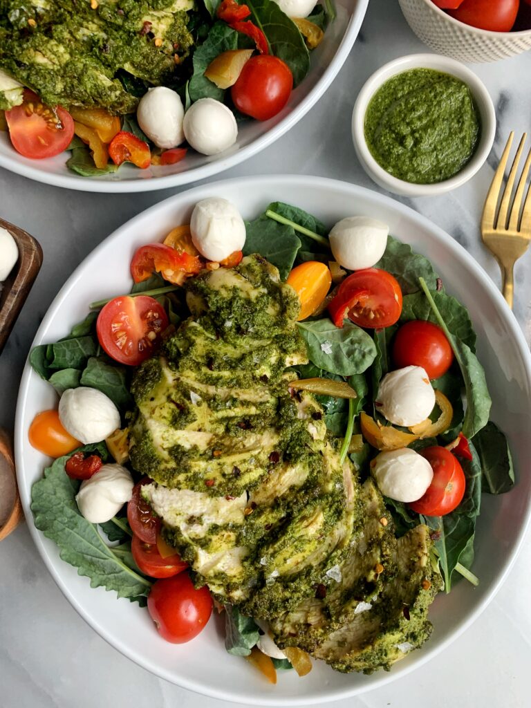 This Pesto Chicken Caprese Salad is the ultimate salad to make everybody. It spices things up in your salad bowl, with your chicken game and the flavors with the tomatoes and mozzarella are out of this world!