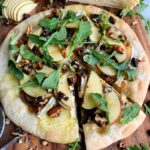 Loaded Hot Honey, Apple + Brie Pizza! A delicious flatbread pizza topped with caramelized onions, candied walnuts, arugula and the most delicious and creamy brie.