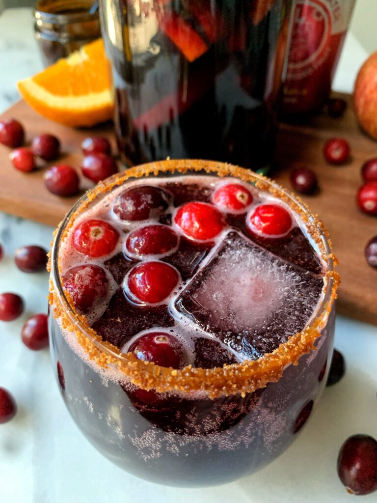 The Best Sparkling Cranberry Sangria! Made with oranges, apples, red wine, sparkling water, cinnamon and no added sugar.