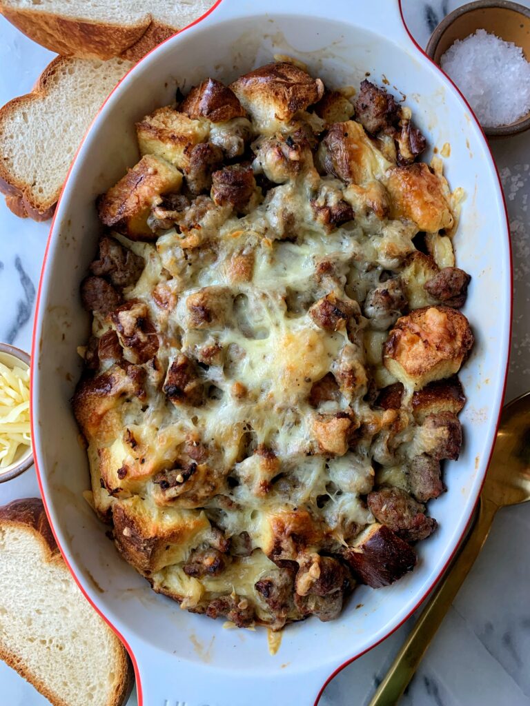 This Savory Sausage and Cheese Challah Pudding is the *best* way to switch things up from the classic cinnamon challah french toast. It is super easy to whip up and an easy recipe when you have leftover challah bread.