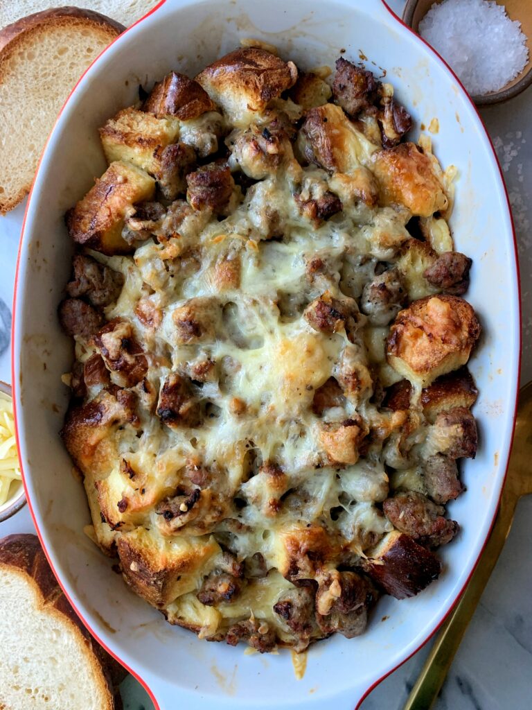 This Savory Sausage and Cheese Challah Pudding is the *best* way to switch things up from the classic cinnamon challah french toast. It is super easy to whip up and an easy recipe when you have leftover challah bread.