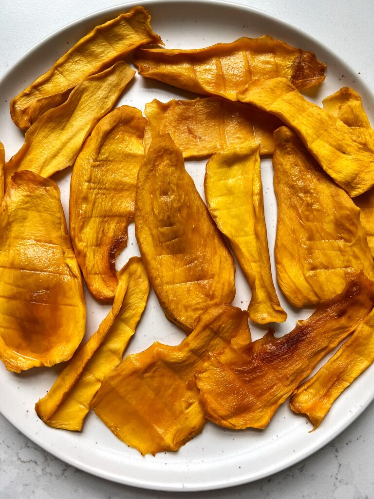 Here's how to make your own dried mango in the oven! No dehydrator needed. This is so easy to make and as someone who is dried mango obsessed, this is a game changer to be able to make my own easily!