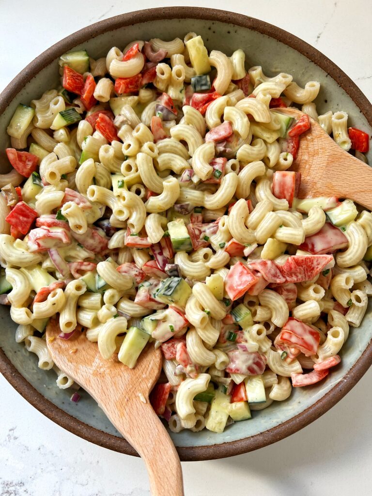 Creamy Whipped Feta Pasta Salad made with gluten-free pasta, olives, cucumbers, roasted red peppers, red onion, tomatoes and tossed in a creamy feta cheese dressing.