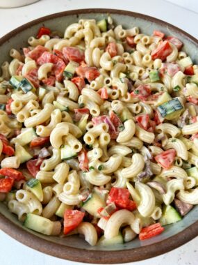 Creamy Whipped Feta Pasta Salad made with gluten-free pasta, olives, cucumbers, roasted red peppers, red onion, tomatoes and tossed in a creamy feta cheese dressing.