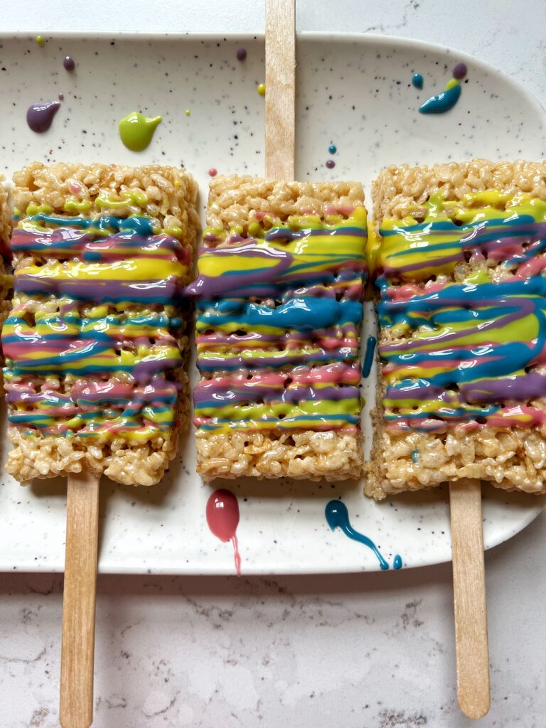 These Rainbow Rice Krispie Treats on a Stick are a family favorite to make for dessert. You only need 3 ingredients to make them and then you can dip or drizzle them in anything you want!