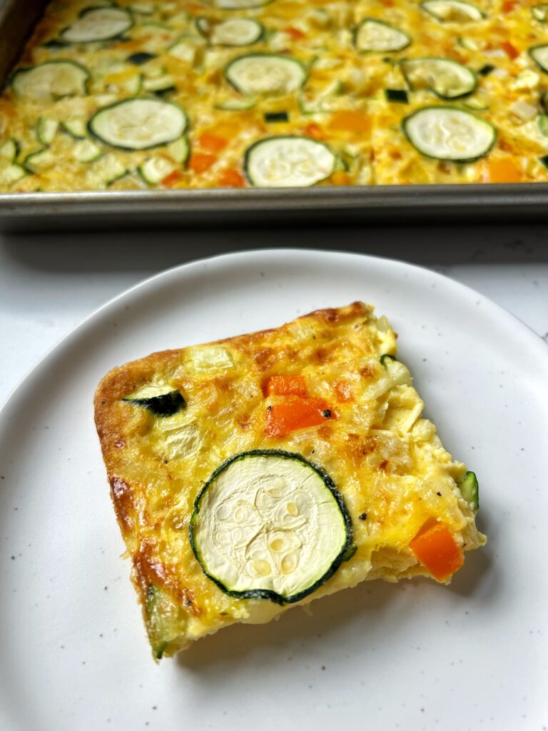 These Sheet Pan Eggs are one of the easiest meals to make. Toss your favorite veggies, cheese and anything you'd like and bake in oven and you have a healthy and delicious meal to have all week long.