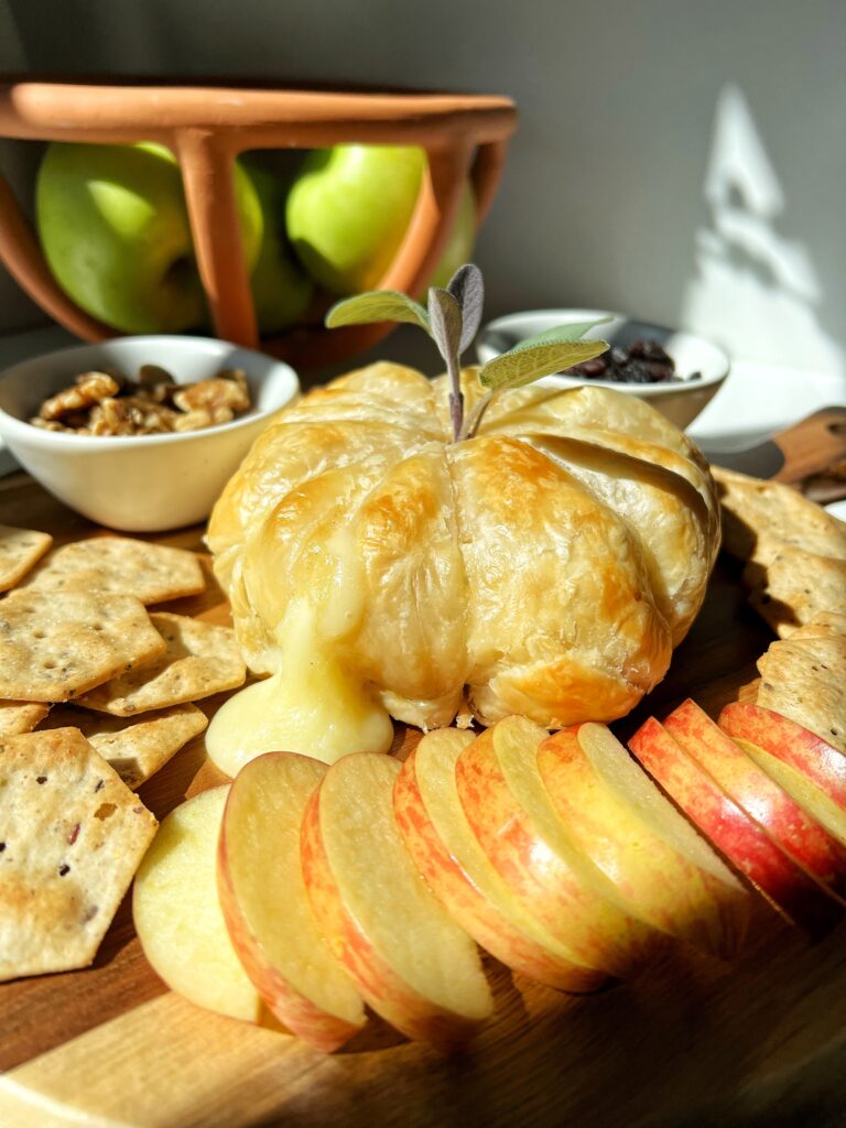 This Pumpkin-Shaped Baked Brie is the ultimate cozy cheesy appetizer to make that is festive, made with just 3 ingredients and is a guaranteed crowd pleaser.